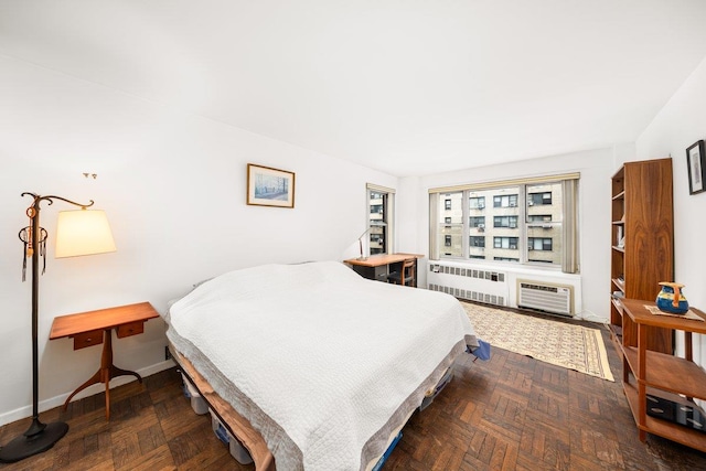 bedroom with baseboards and radiator