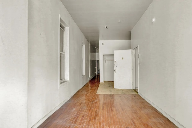 hallway with light wood-style floors
