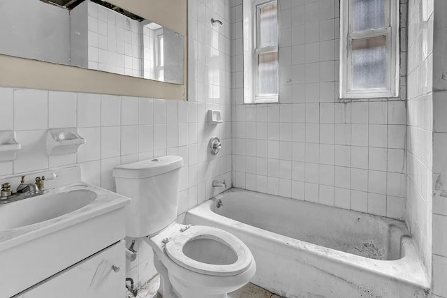 full bathroom with tile walls, shower / bathing tub combination, vanity, and toilet