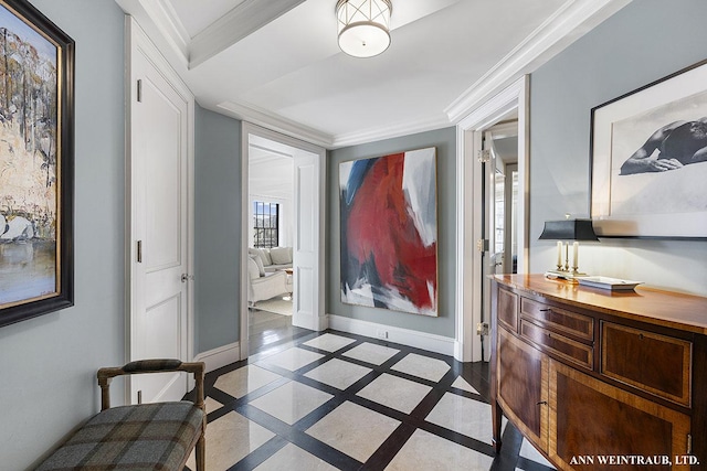 entrance foyer featuring baseboards and crown molding