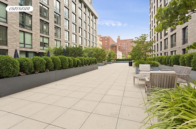 view of community featuring a view of city and a patio