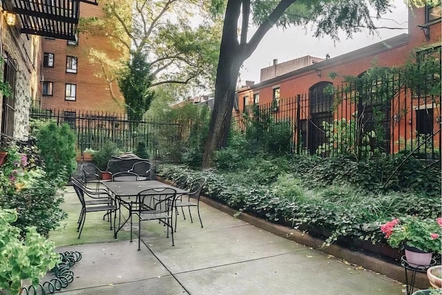 exterior space with a patio, outdoor dining area, and fence