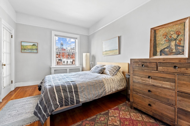 bedroom with baseboards and wood finished floors