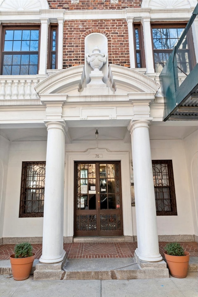 entrance to property with brick siding and french doors