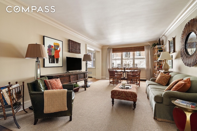 living area featuring ornamental molding, light colored carpet, and baseboards