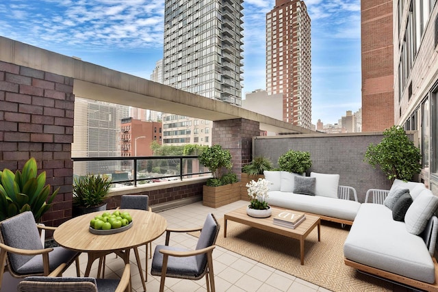 view of patio / terrace with an outdoor hangout area, a balcony, and a city view