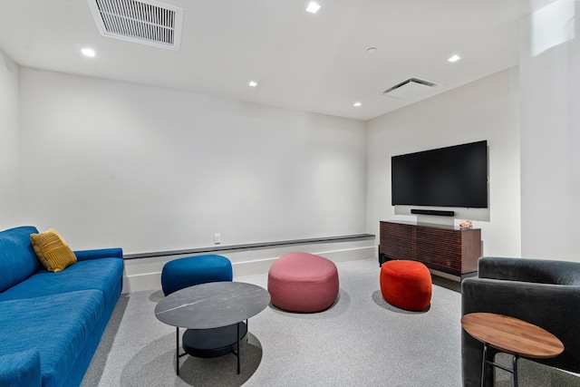 carpeted living room featuring baseboards, visible vents, and recessed lighting