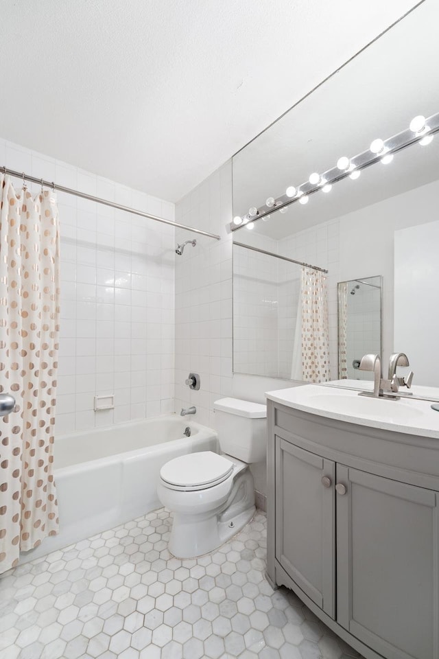 full bathroom featuring a textured ceiling, vanity, shower / bath combo with shower curtain, and toilet