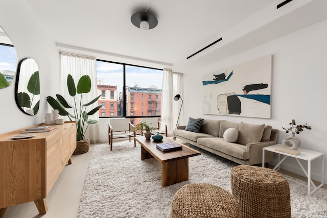 living area with a city view and wood finished floors