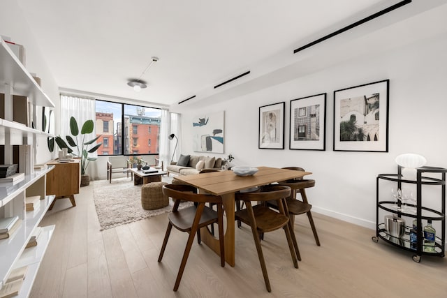 dining room featuring light wood-style floors and baseboards