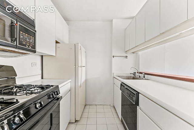 kitchen with black appliances, light countertops, light tile patterned flooring, white cabinetry, and a sink