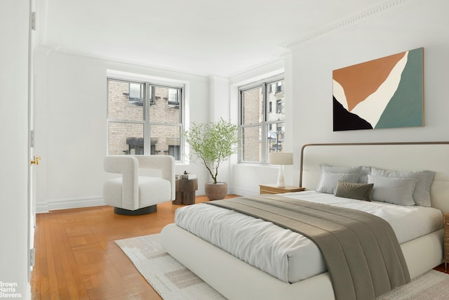 bedroom with ornamental molding and baseboards