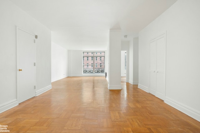 unfurnished room with baseboards