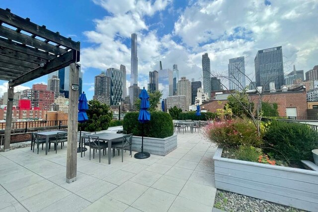 view of property's community with a city view, a patio area, and a pergola