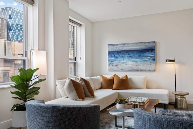 living room with wood finished floors, a wealth of natural light, and baseboards