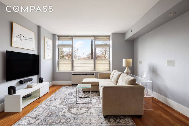 living room featuring baseboards and wood finished floors