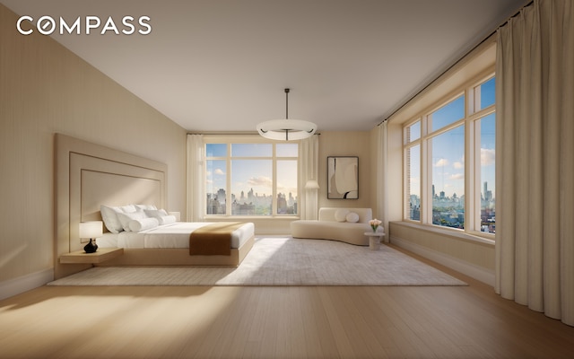 unfurnished bedroom with a view of city, baseboards, and wood finished floors