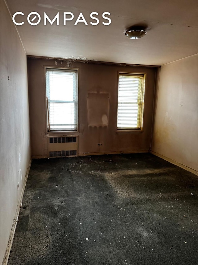 spare room featuring radiator