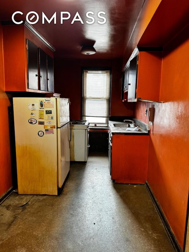 kitchen featuring a sink and freestanding refrigerator