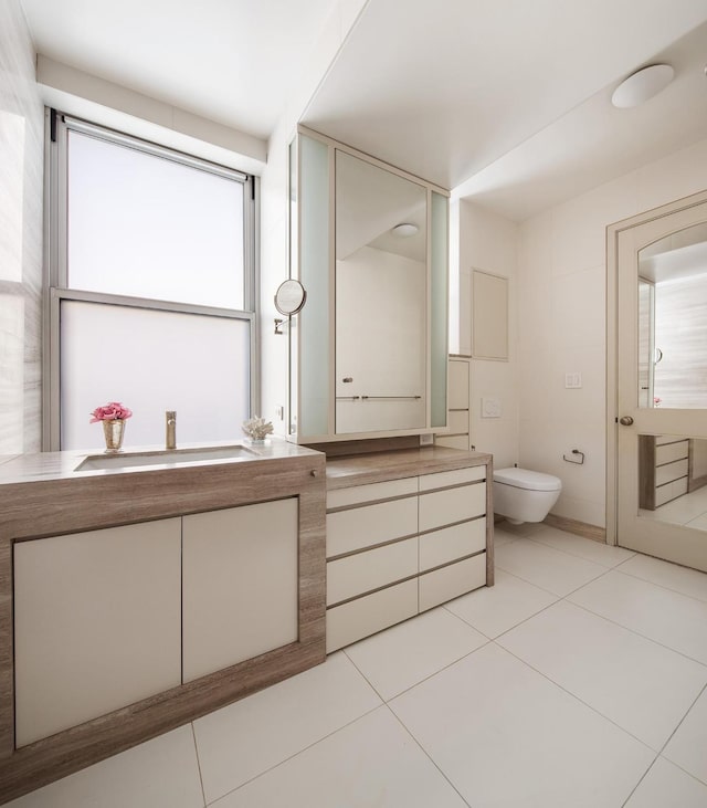 bathroom featuring toilet, tile patterned floors, and vanity