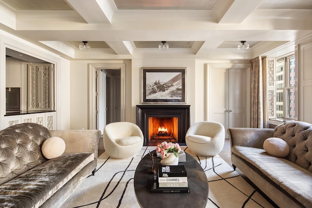 sitting room featuring a warm lit fireplace, coffered ceiling, and beamed ceiling