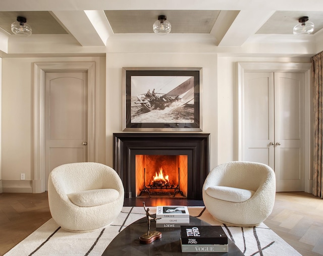 living area featuring a warm lit fireplace