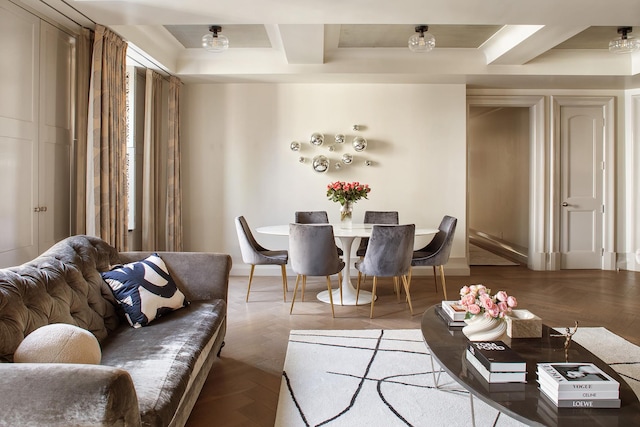 interior space with coffered ceiling, beamed ceiling, and baseboards