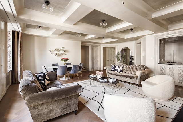 living room featuring arched walkways, coffered ceiling, and beam ceiling