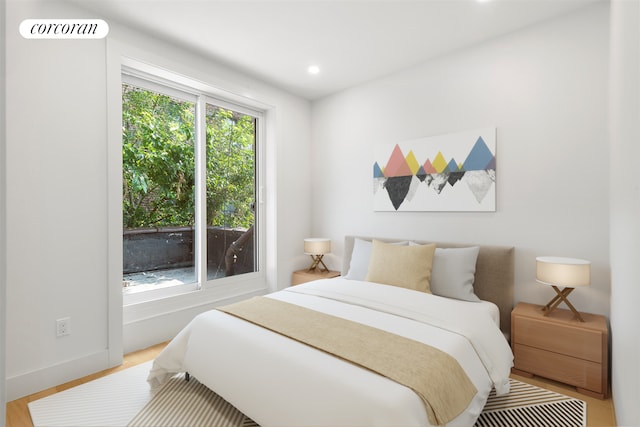 bedroom featuring baseboards, wood finished floors, visible vents, and recessed lighting