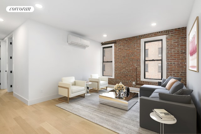 living room featuring recessed lighting, visible vents, light wood-style flooring, a wall mounted AC, and brick wall