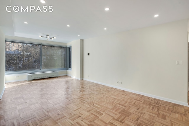 empty room with recessed lighting and baseboards