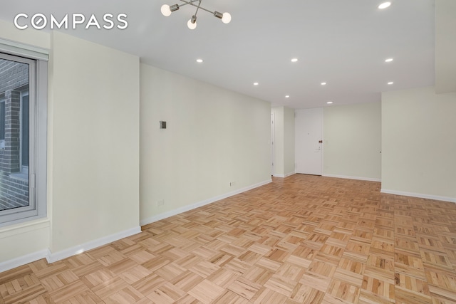 unfurnished room featuring recessed lighting and baseboards