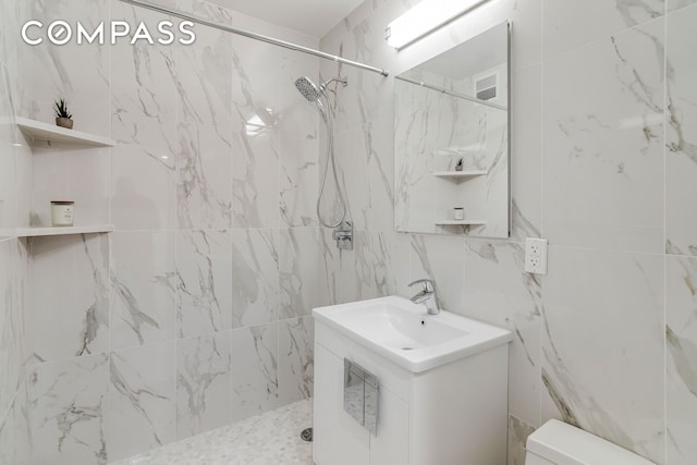 full bathroom with visible vents, toilet, and tiled shower