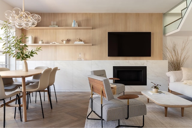 living area featuring a chandelier and a high end fireplace