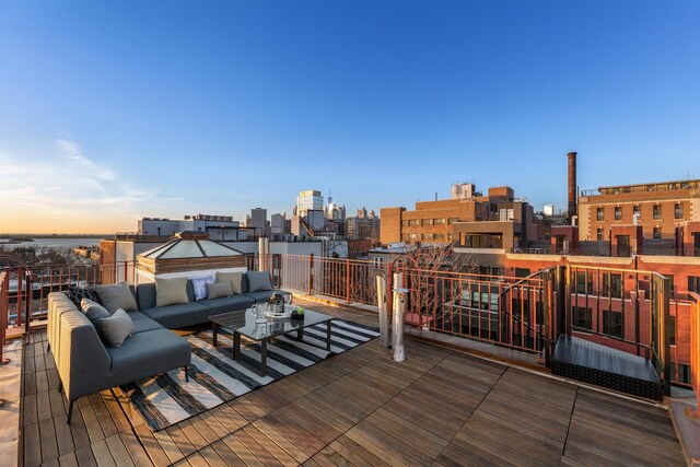 deck at dusk featuring outdoor lounge area and a city view