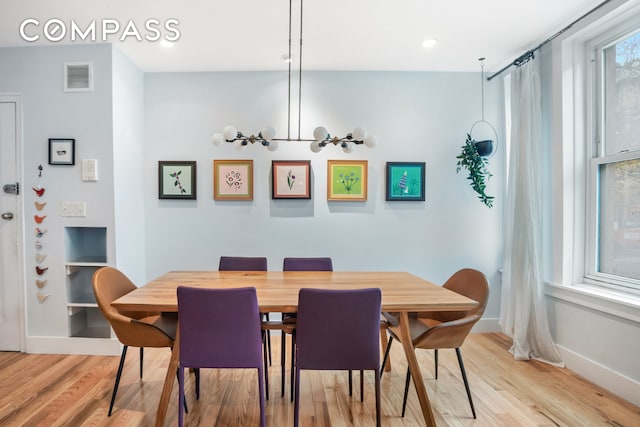 dining space with light wood-style flooring, baseboards, a chandelier, and recessed lighting