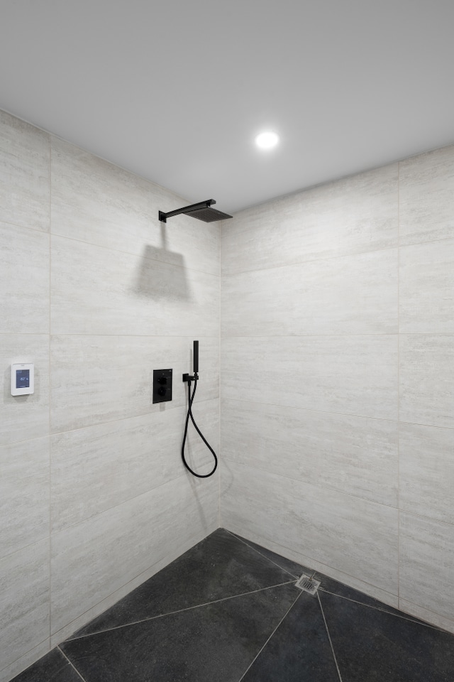 full bath with tile patterned flooring and a tile shower