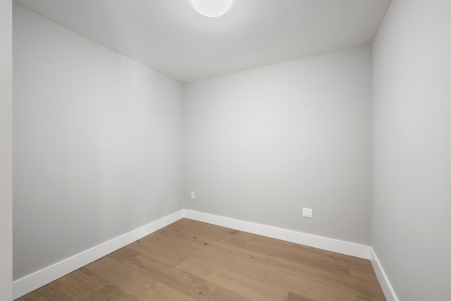 empty room featuring light wood-type flooring and baseboards