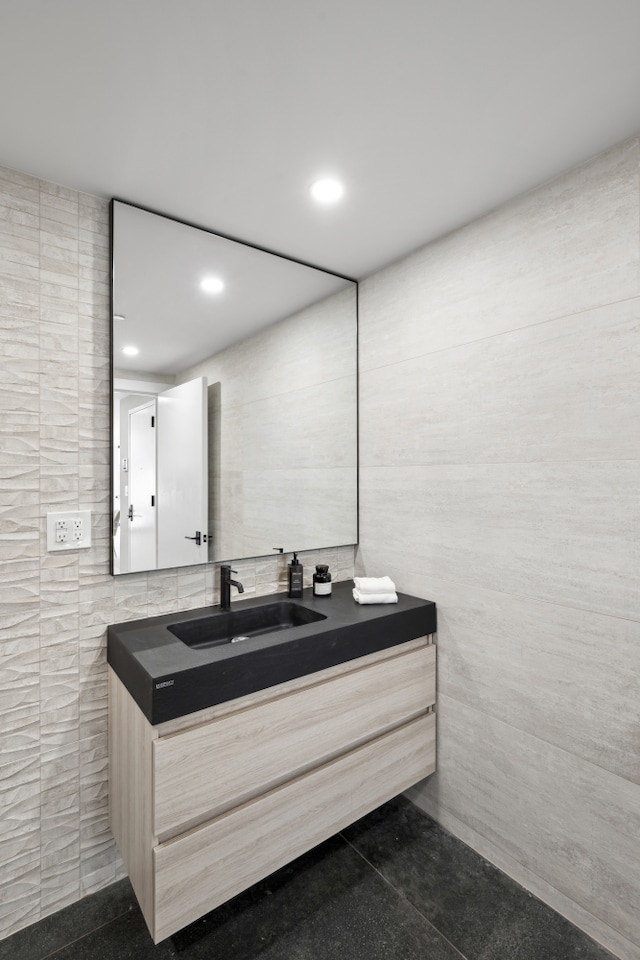 bathroom with vanity, tile walls, and recessed lighting