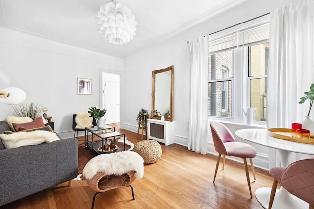 living area featuring wood finished floors and baseboards