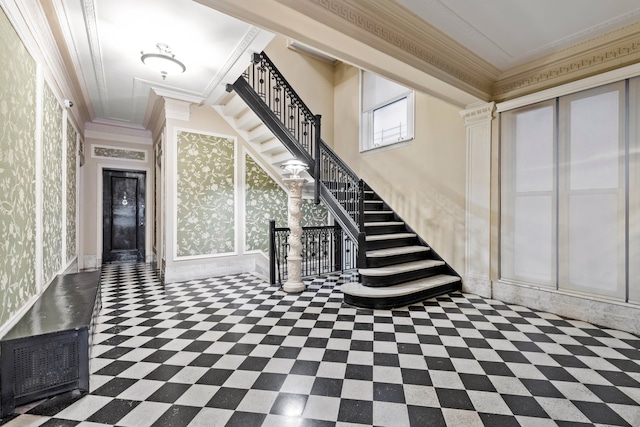 entryway with stairs, wallpapered walls, and crown molding