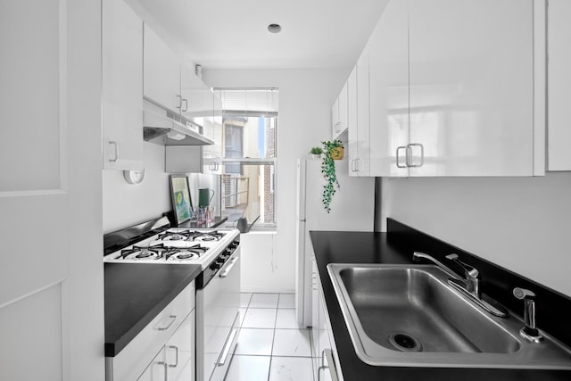 kitchen featuring dark countertops, under cabinet range hood, white range with gas cooktop, white cabinets, and a sink