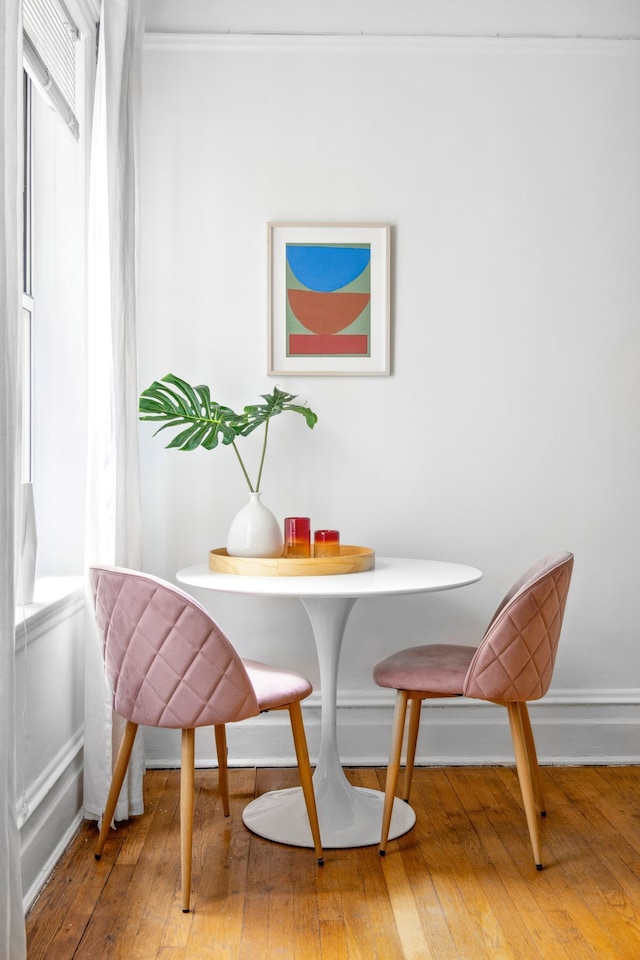 dining room featuring hardwood / wood-style floors and baseboards