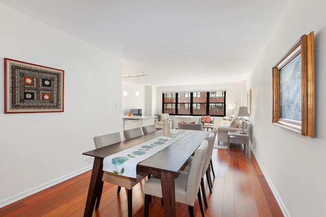 dining area featuring hardwood / wood-style floors and baseboards