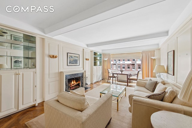 living area featuring a fireplace and beamed ceiling