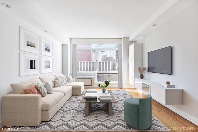 living area with light wood finished floors and baseboards