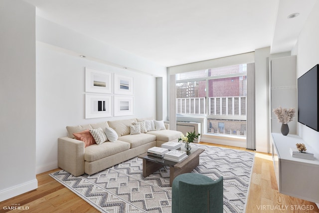 living room with light wood-type flooring and baseboards