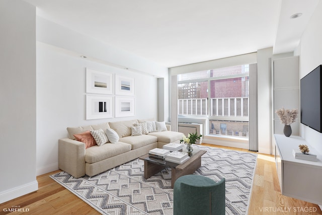 living room with light wood-style floors and baseboards