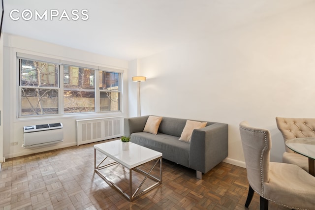 living room with heating unit, radiator heating unit, and baseboards