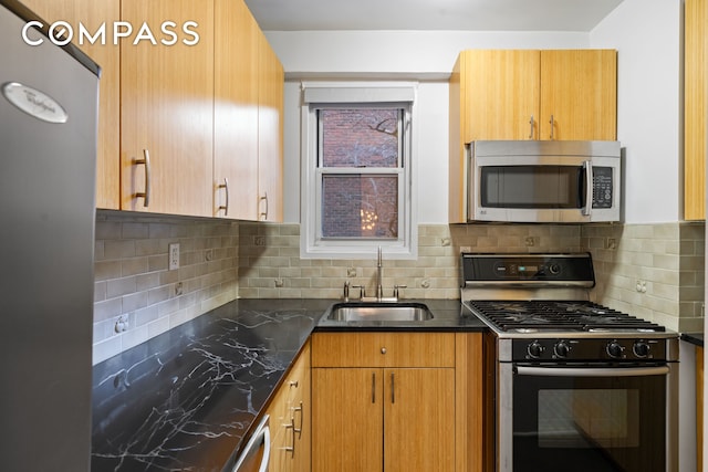 14 Horatio St Unit 2J, New York City, NY 10014 - kitchen with appliances with stainless steel finishes, a sink, tasteful backsplash, and dark stone counters